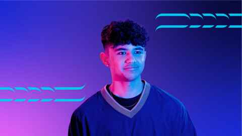 Student standing in front of coloured backdrop