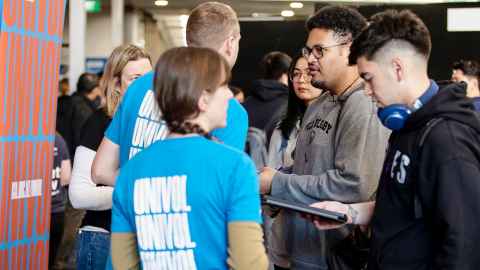 Photo of students and volunteers at a previous internship and graduate career expo.