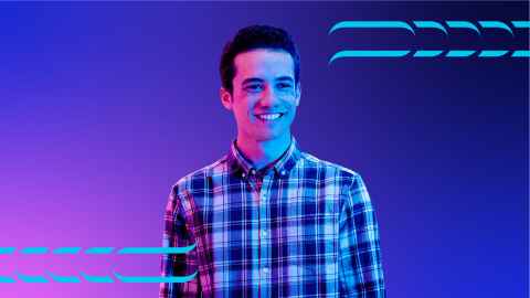 Student standing against a pink and blue background.
