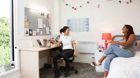 Two students in a room at the Carlaw Park accommodation.