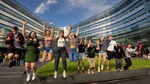 Group of happy students jumping with excitement.