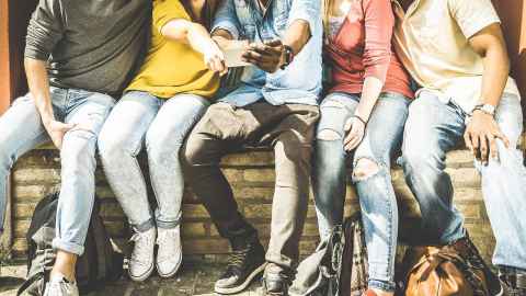 students looking at something on a cellphone