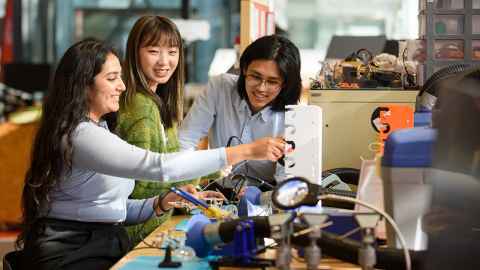 Group of students working together in a workshop.