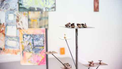 Close up of small crafted sculptures on platformed stand.