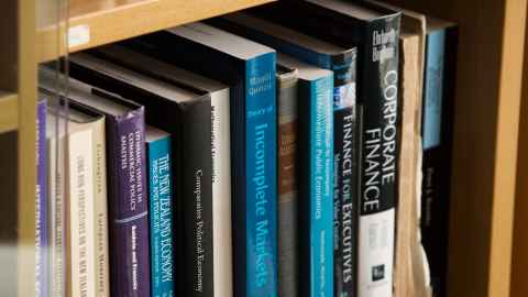 Section of books on a bookshelf.