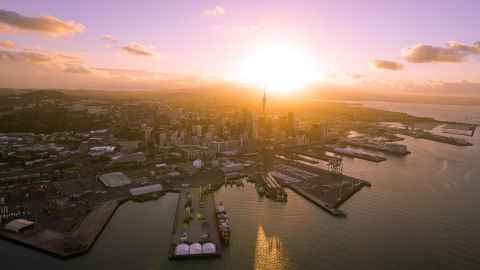 Auckland city on the harbour during sunset.