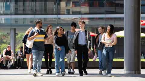 Group of students walking across a courtyard.