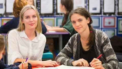 two EDSW students at desk