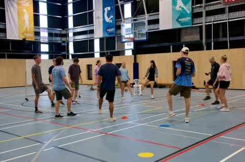 People playing indoor basketball