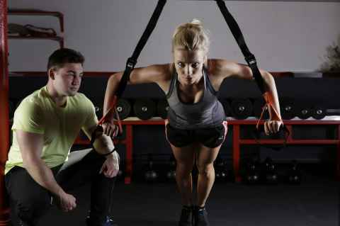 Woman in a gym with a trainer