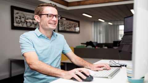 A man sits at a computer 