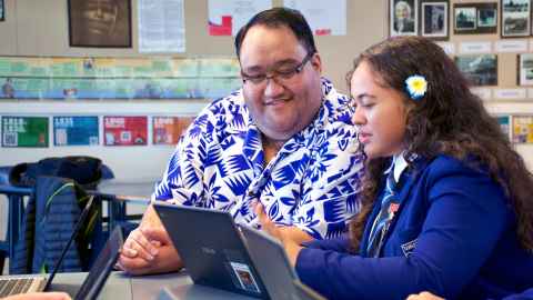 Two people in front of laptop