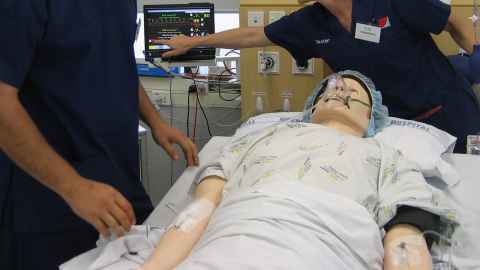 Medical dummy in hospital gown