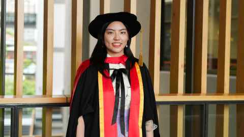 Photo of Clara Han in her graduation regalia. 