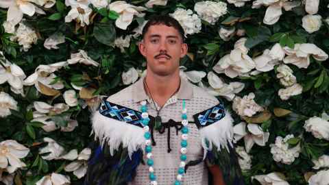 Photo of Joshua Brown in his graduation regalia. 