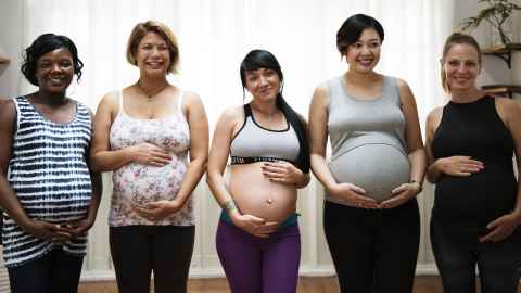 Pregnant women holding their bellies