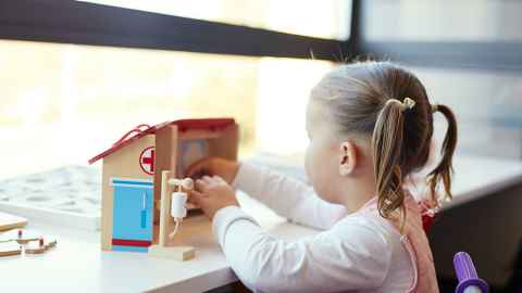 A young toddler playing with a toy