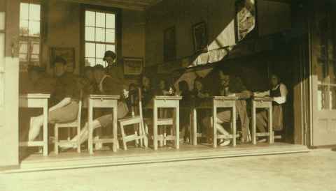 Pupils sitting at desks in a Kaikohe Native School classroom, 1939