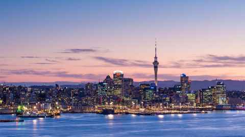 The image shows the cityscape of Auckland at night: We may be in a crisis, but the water will keep flowing, the power will stay on, and the sewers will keep working . Photo: iStock