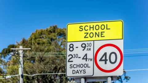 School zone speed limit sign for certain hours and on schooldays