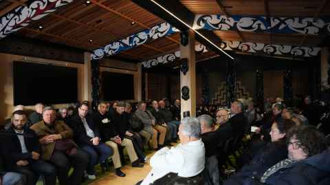 Whānau listening to kaikōrero inside Tūtahi Tonu