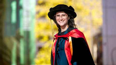 Head and shoulders image of PhD graduand Carolina Panico with a yellow blurred background.