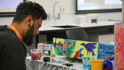 Tongan artist Taniela Petelo from the Seleka International Art Society Initiative transforming the ordinary into a work of art during ITAC7 . Photo: FPS Photo