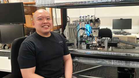 JC in front of lab equipment