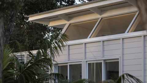 Side of house designed by Sarosh Mulla and team at Pac studio, featuring steel, wood and glass