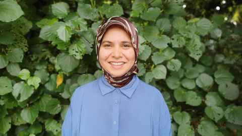 Farha stands in front of a kawakawa bush