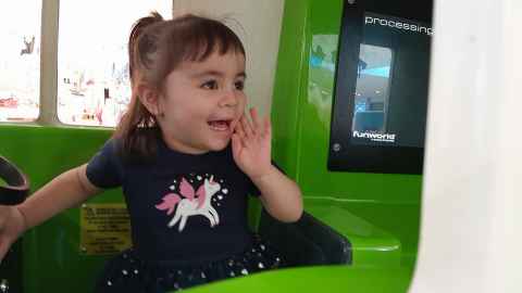 Eva, who has wheeze, in a toy vehicle.