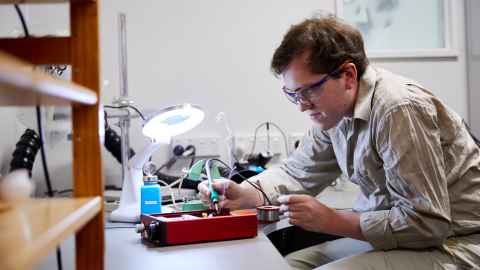 Bryan working on a motor at his lab bench