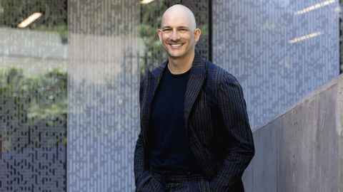Professor Peter Saxton in front of a glass wall.