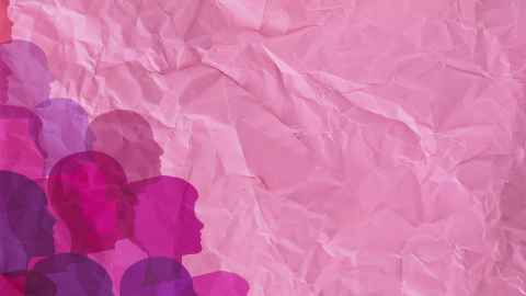 Silhouette of female profiles against pink paper