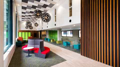 An open plan area with modern furniture and large windows.