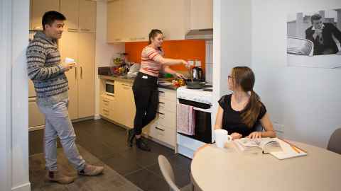 Group of three students hanging out in a flat together