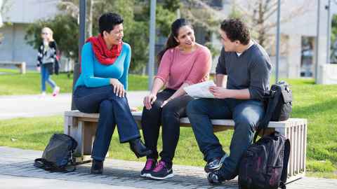 Students sitting on a bench.