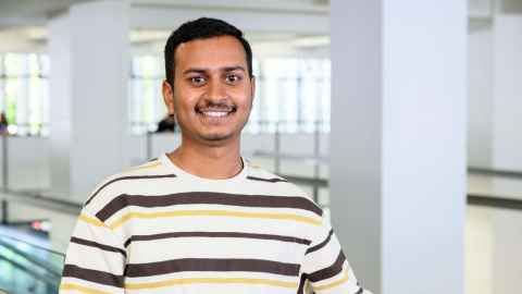 Smiling man indoors in large open area indoors