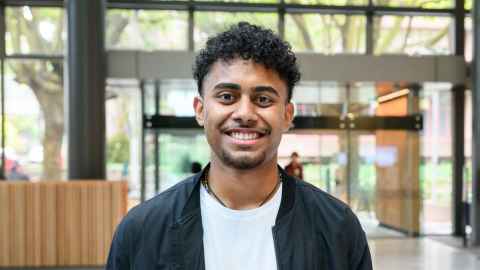 Smiling man standing in a large atrium area