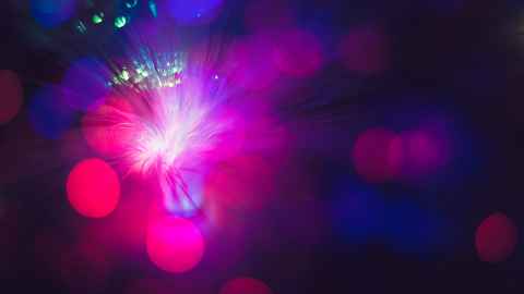 An abstract graphic of pink and purple circles overlayed on a dark background.