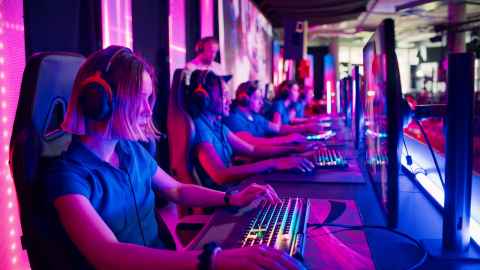 Row of gamers playing at gaming PCs